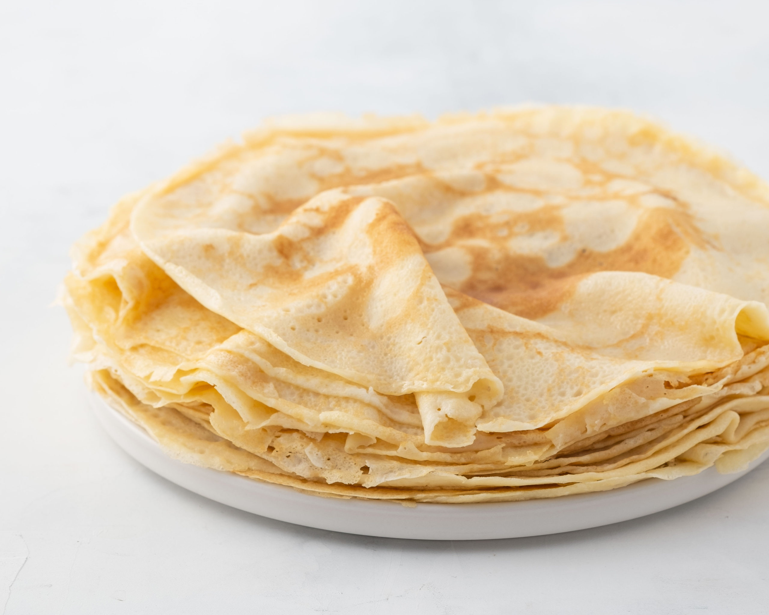 Crepes, Thin Pancakes With Honey On A White Plate. Marble Background ...